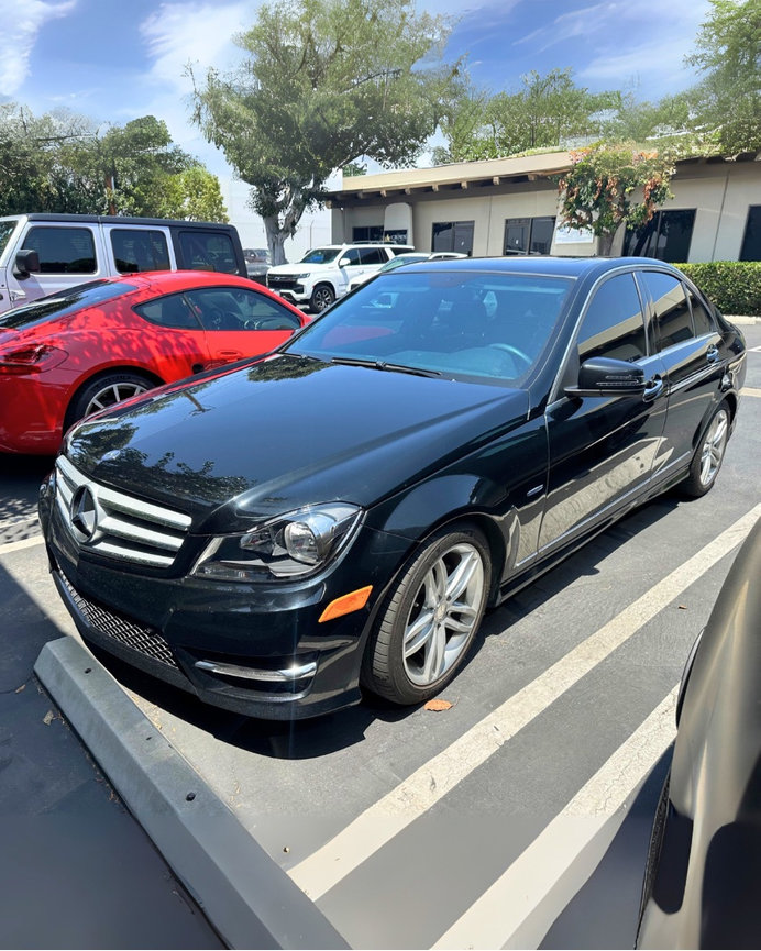 Black Mercedes C250 parked in front of The Prestige Companies Auto Upholstery in Anaheim, California.